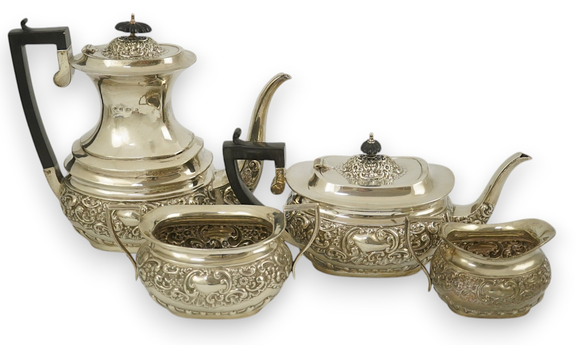 An Edwardian embossed silver four piece tea and coffee set, by S. Glass